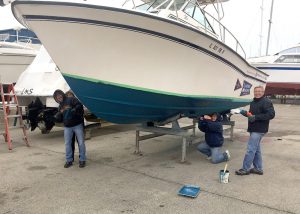 members painting the club's boats